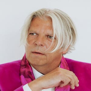 Stephane Horta in pink blazer with thoughtful expression